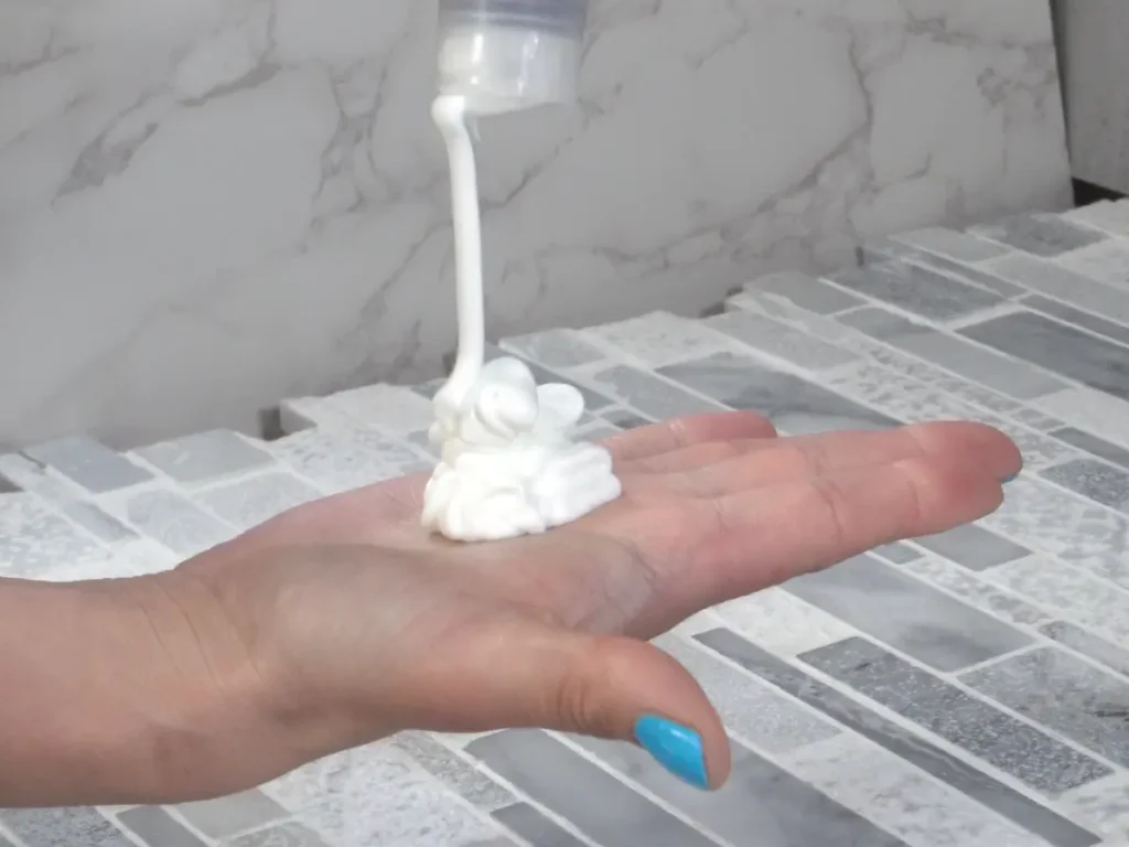 pouring homemade lotion on hand