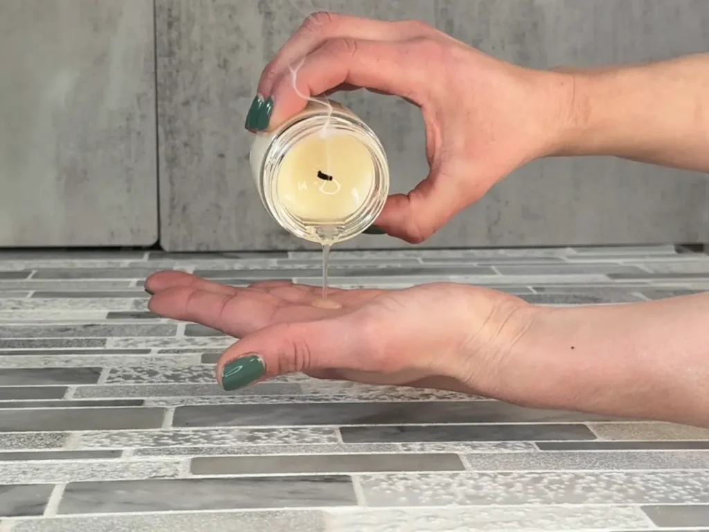 pouring massage candle on to hand