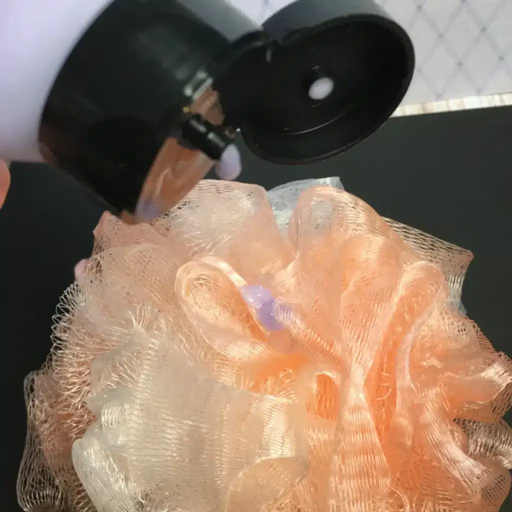 putting diy body wash on luffa