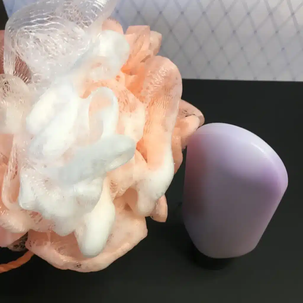 soapy luffa next to body wash