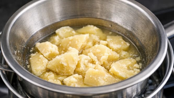 cocoa butter melting in double boiler for skincare formulation