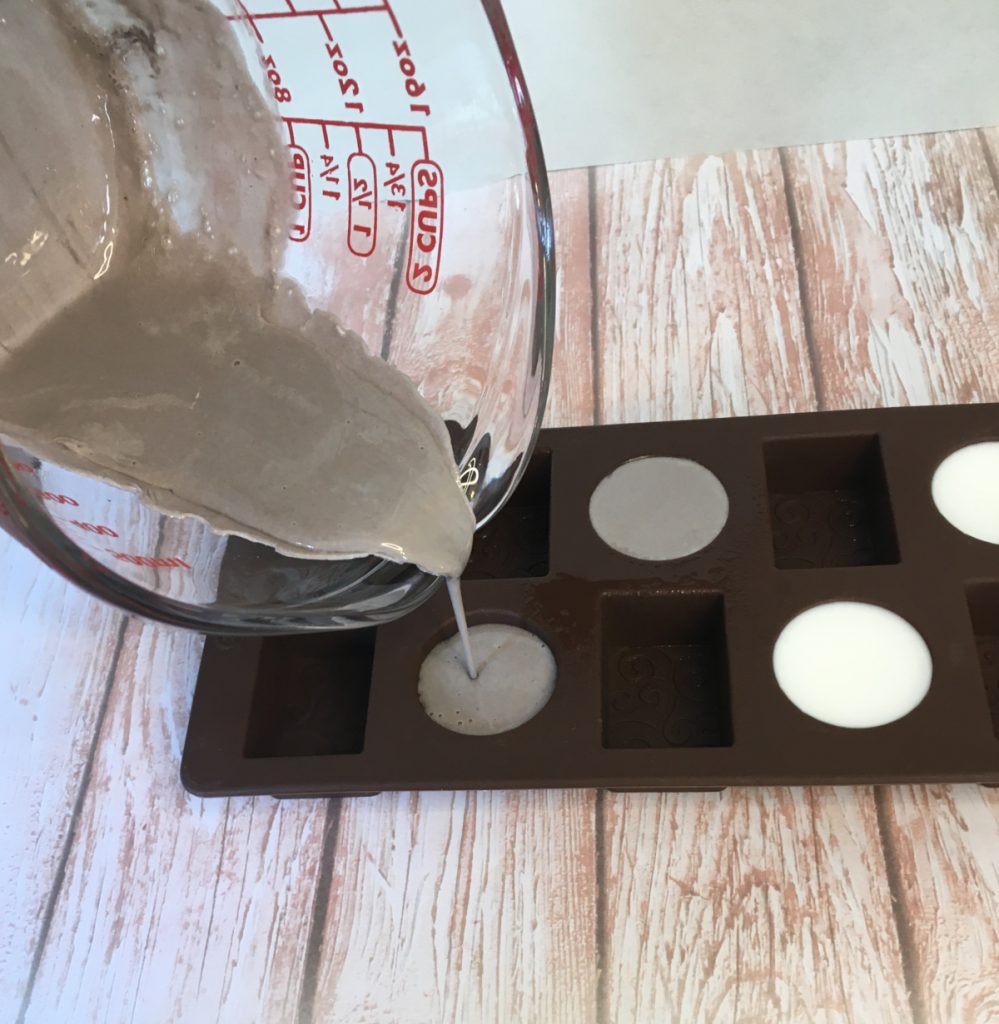 pouring brown melt and pour soap into chocolate mold