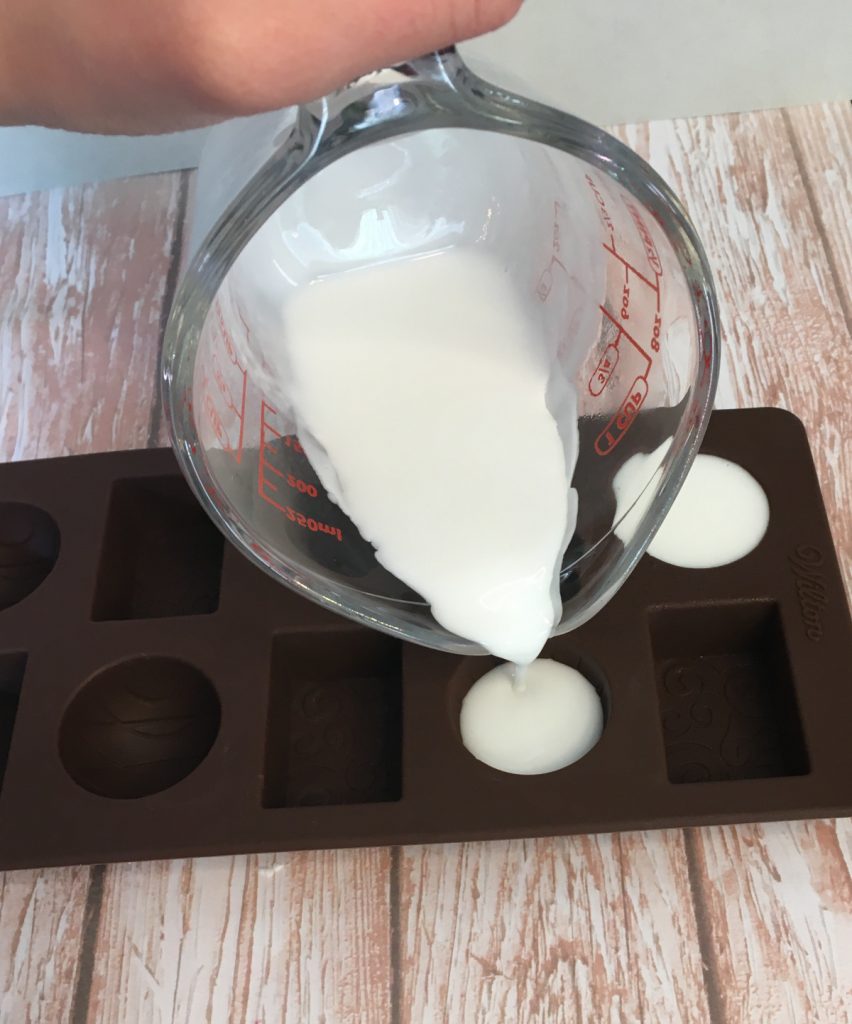 pouring soap into chocolate molds