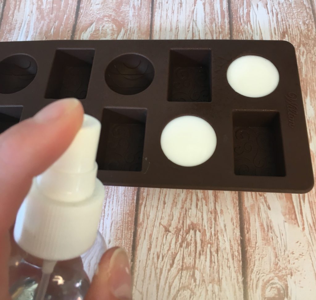 spraying melt and pour soap with rubbing alcohol