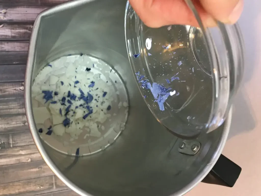 adding candle color to pouring pot