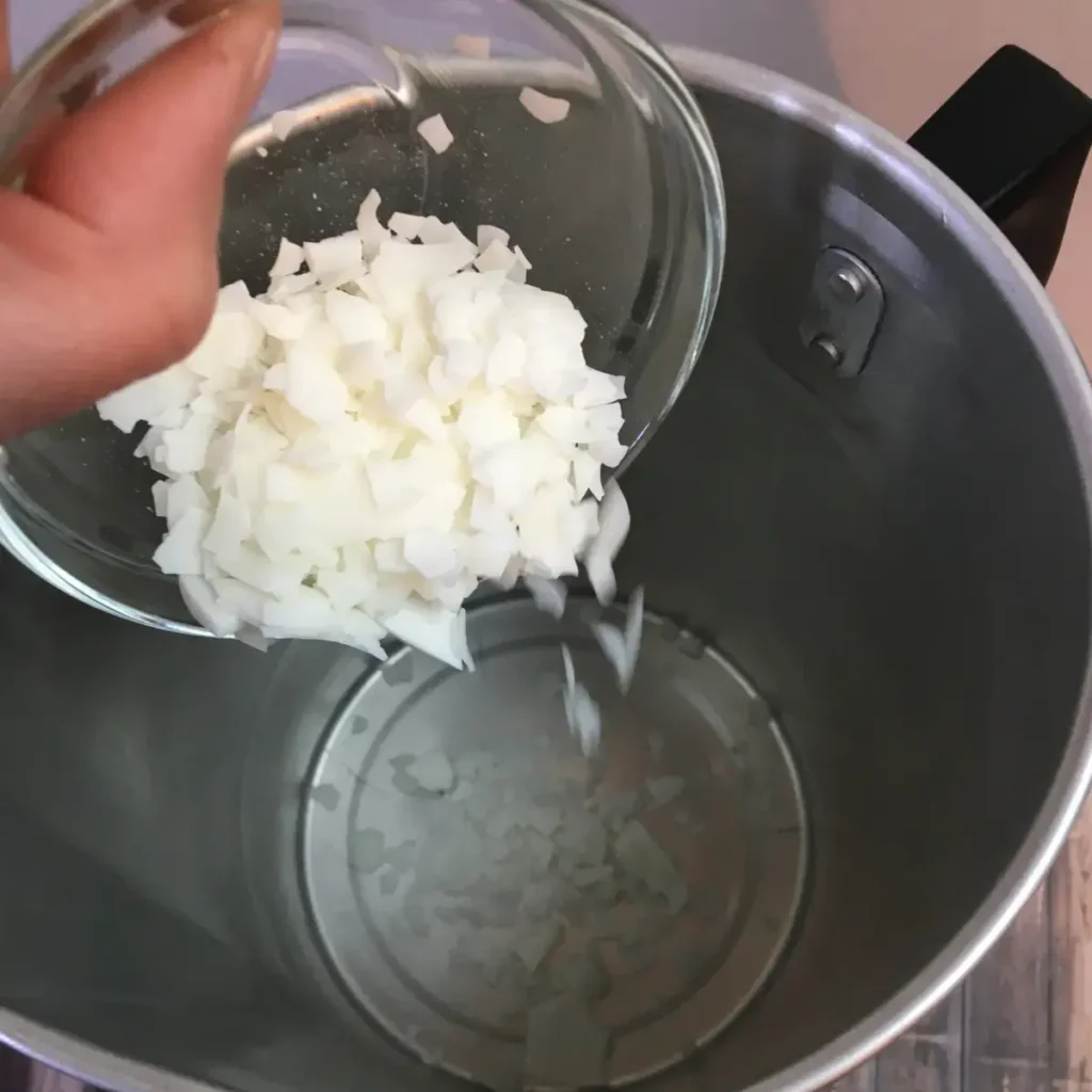 adding soy wax to pouring pot