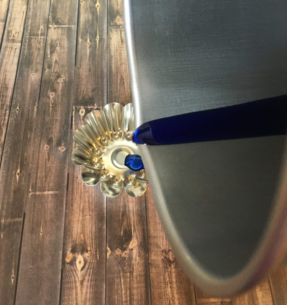 pouring soy candle wax into floating candle mold