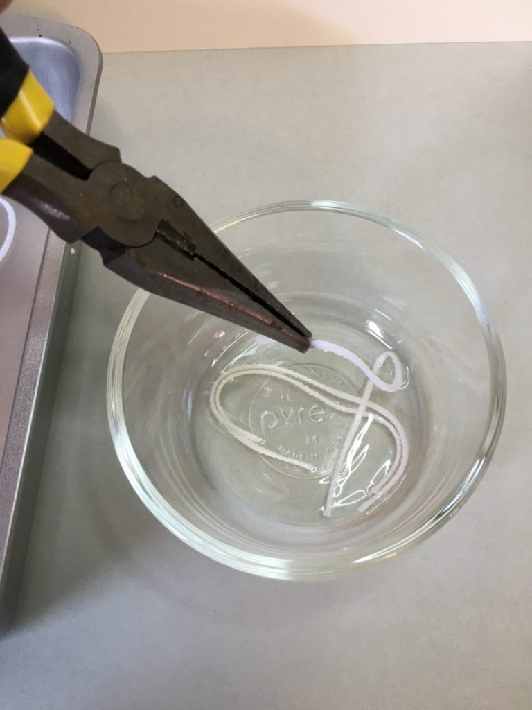 removing wicks from melted wax