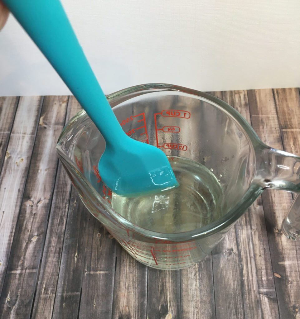 mixing rainbow fragrance oil into the soap base