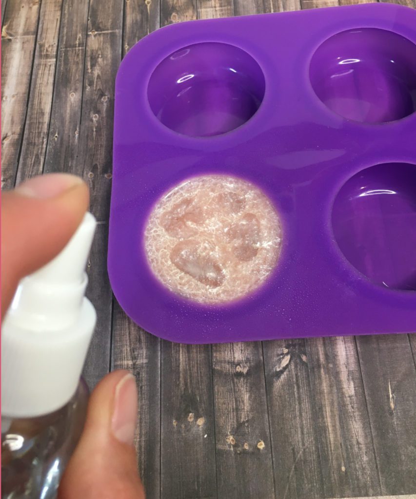 spraying luffa soap with rubbing alcohol