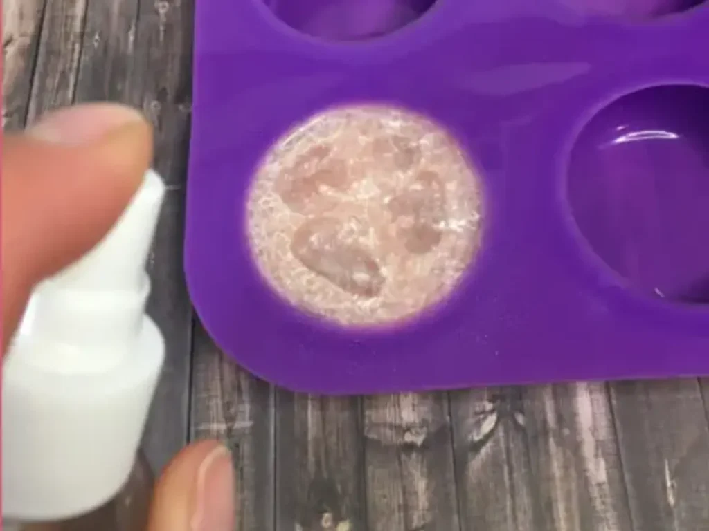 spraying melt and pour soap with rubbing alcohol to get rid of bubbles on top