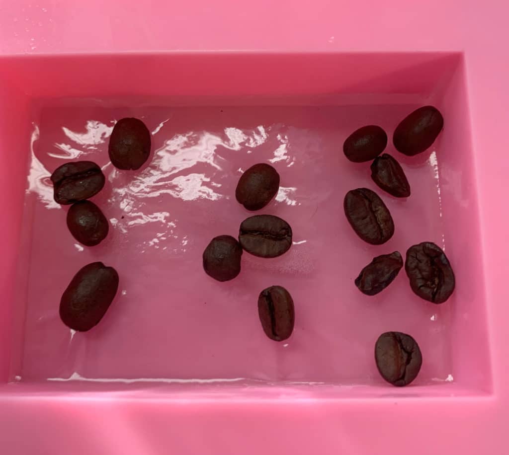 coffee beans placed on melt and pour soap