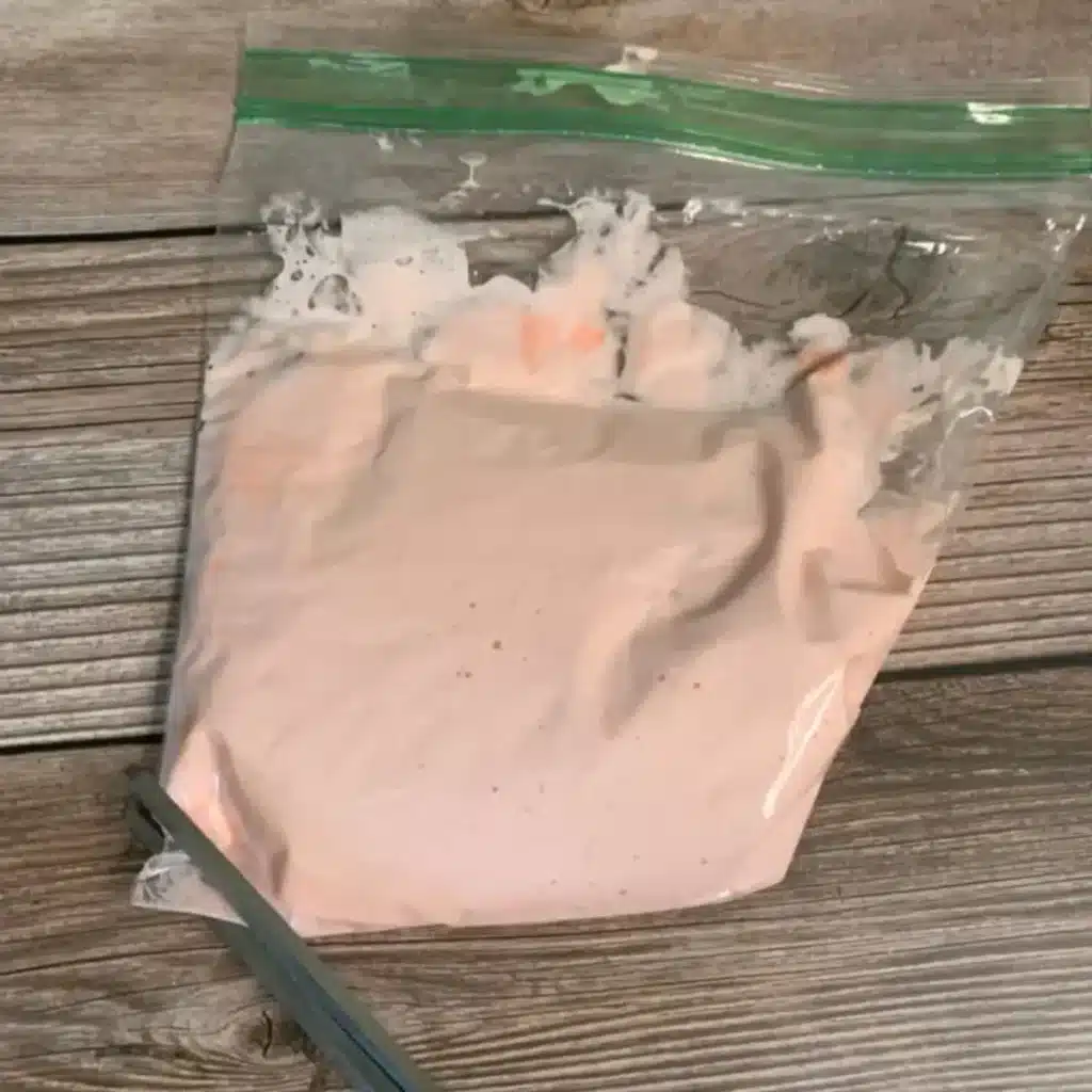 cutting the corner of baggie with whipped sugar scrub