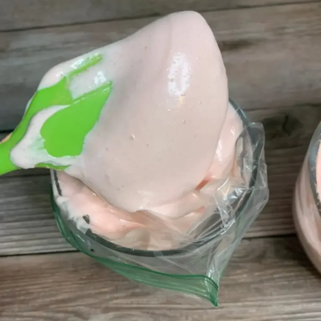 putting whipped soap base into a baggie to pipe into container