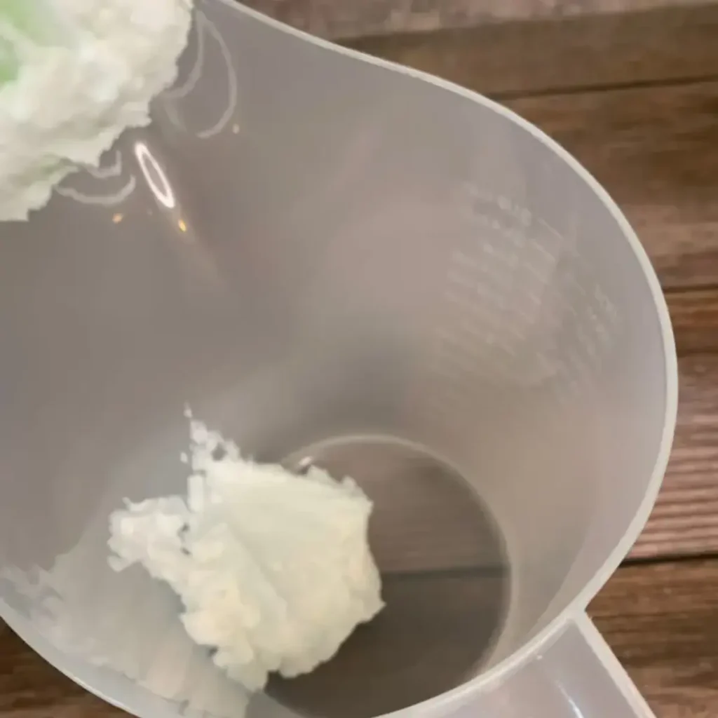 whipped soap base being added to mixing container
