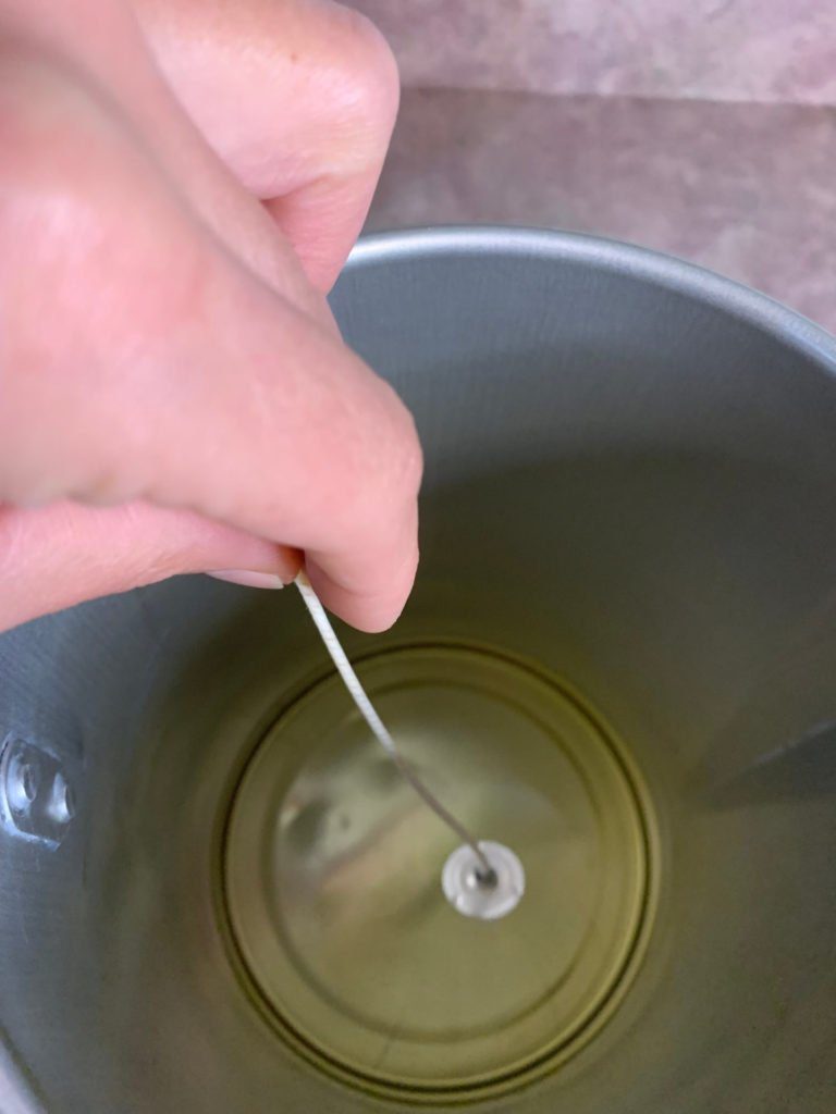 dipping wick into oil