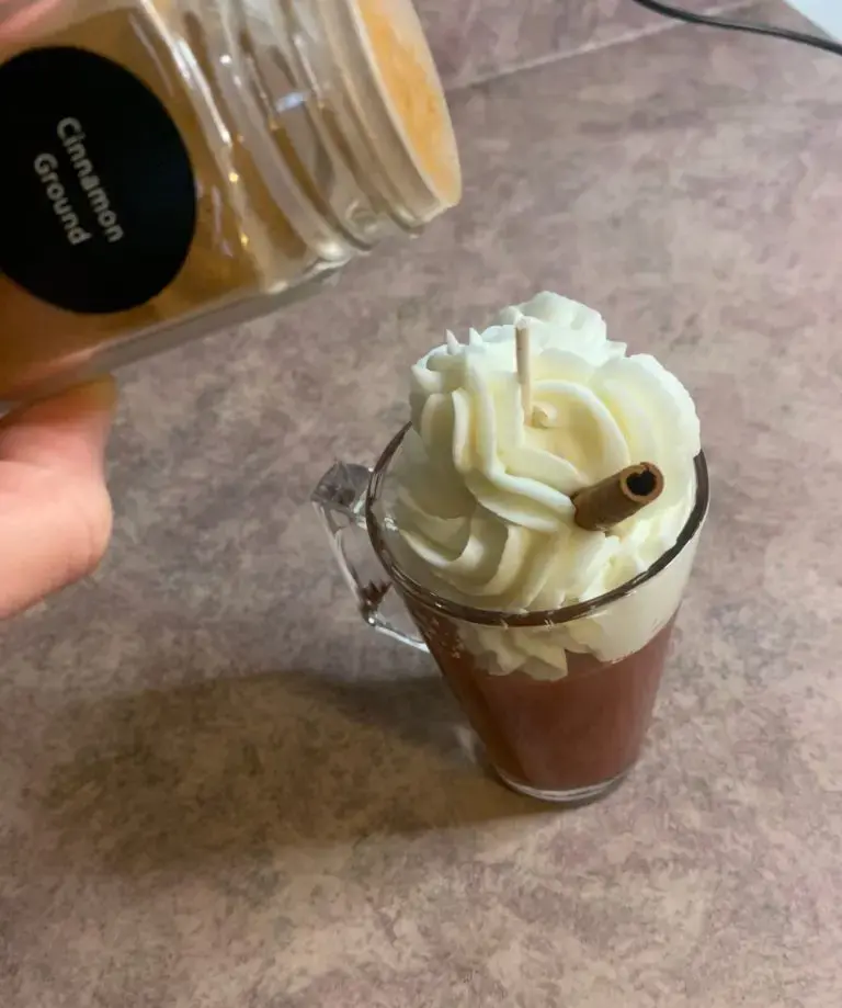 putting-ground-cinnamon-on-candle-top 