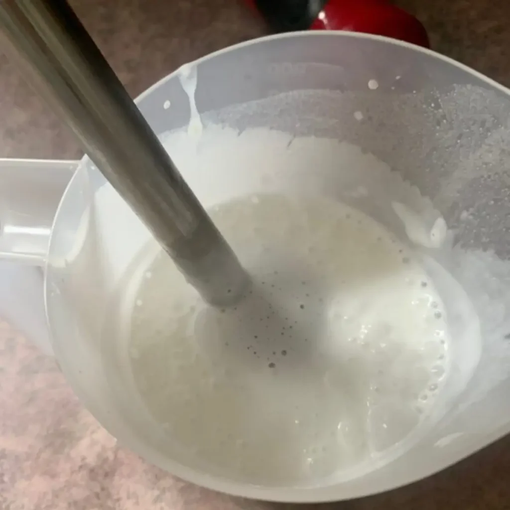 showing consistency of lotion while mixing with immersion blender