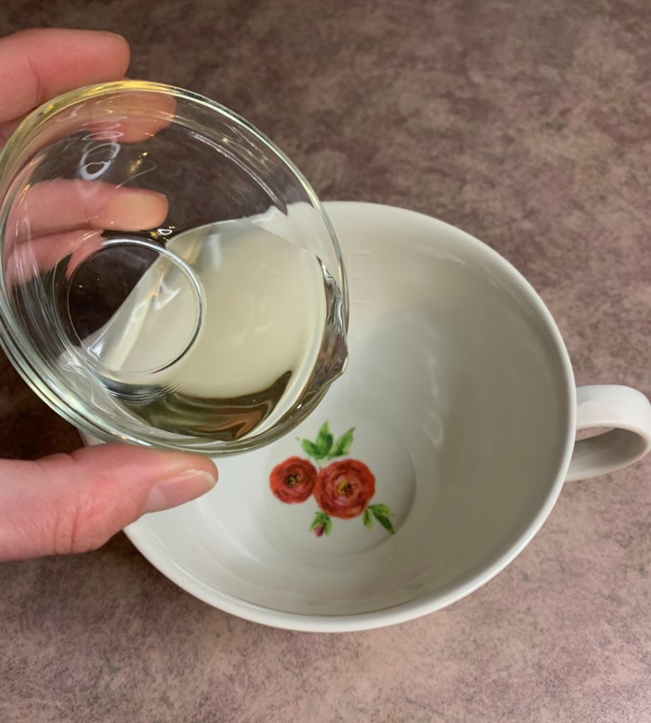 adding sweet almond oil to container for salt scrub