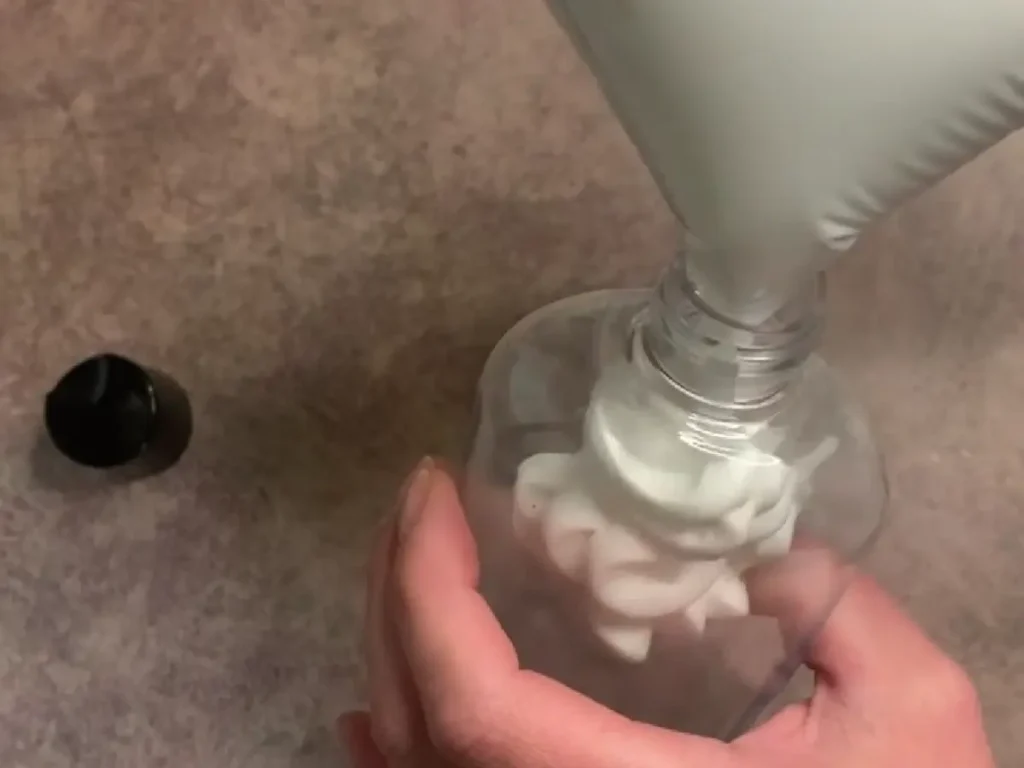 putting lotion into bottle