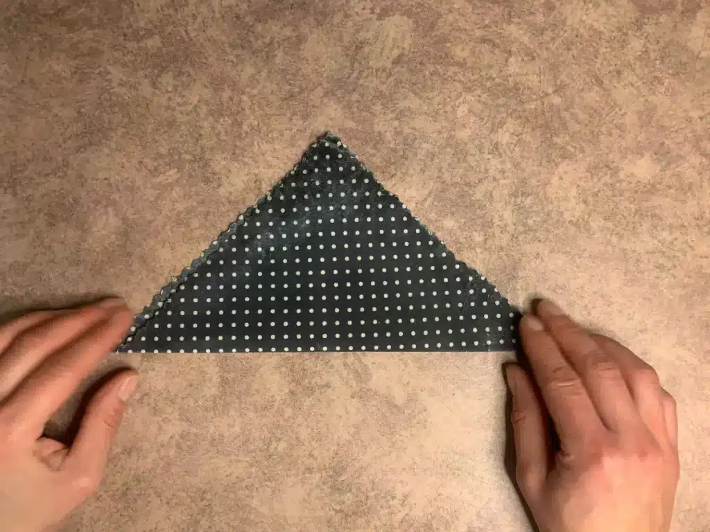 beeswax wrap showing how to fold in half to triangle