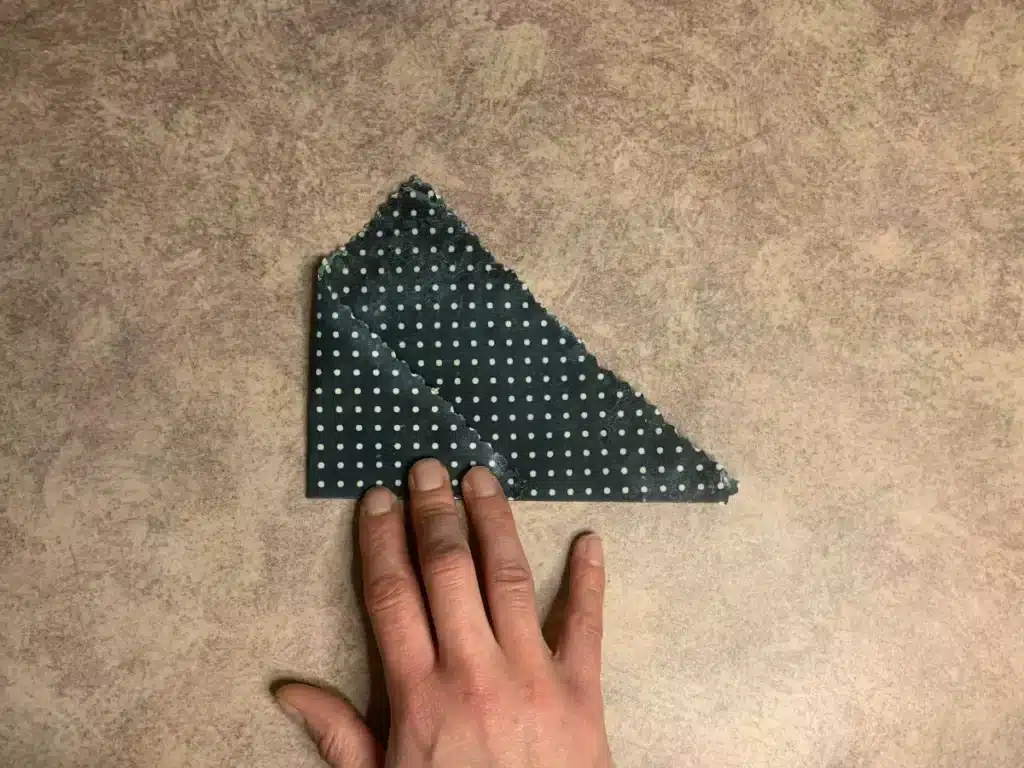 beeswax wrap showing how to fold one side in