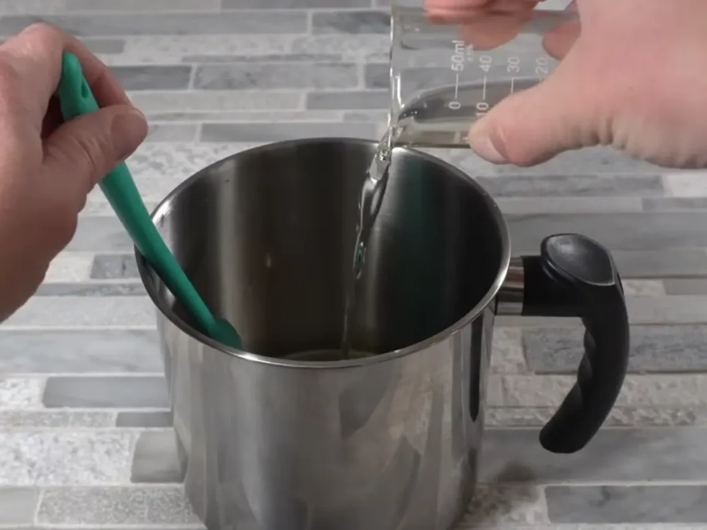 adding fragrance oil to candle wax for making a whipped candle