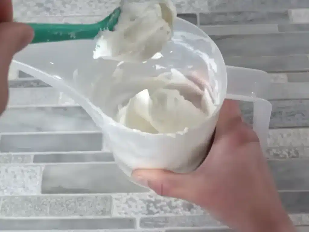 checking the consistency of candle wax to pipe it