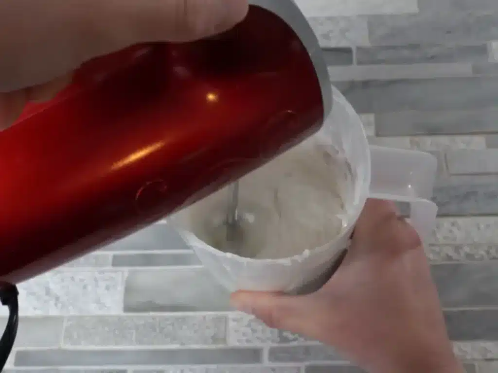mixing soy wax with a hand mixer to make it soft and pipeable
