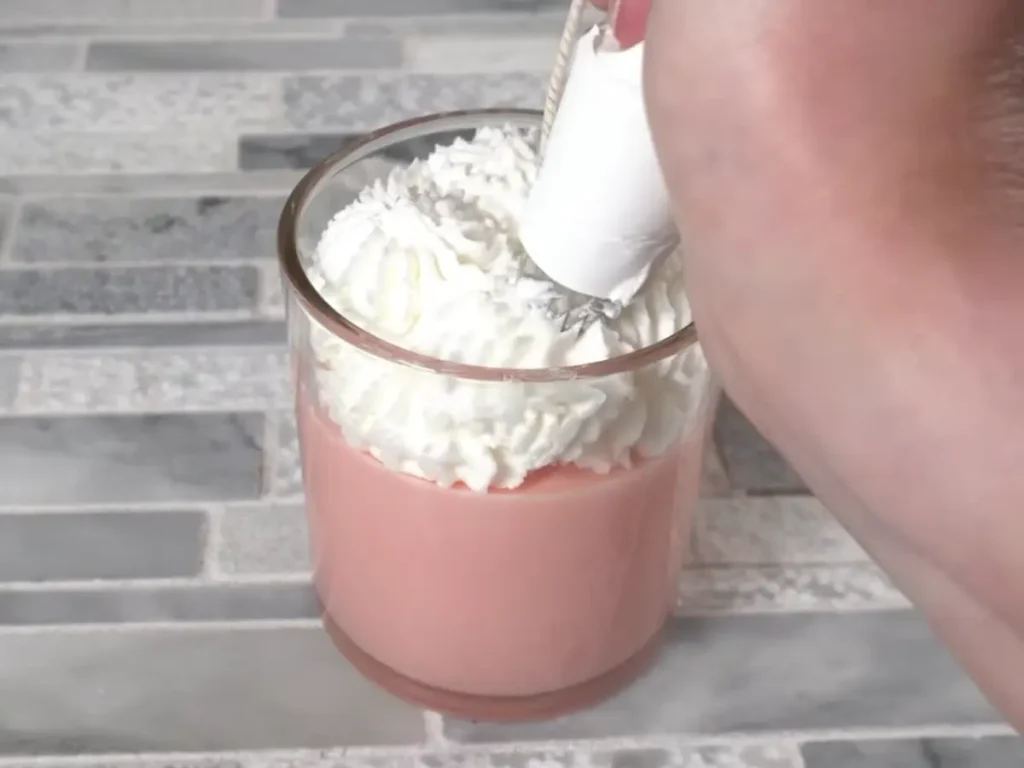 pipping candle top with frosting to make it decorative