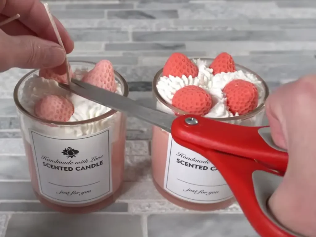 trimming the wick for candles with scissors