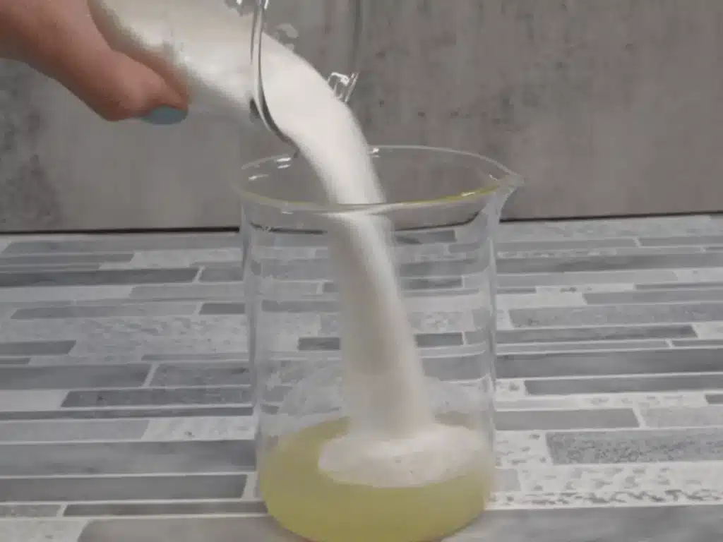 pouring sugar into diy body polish mixture