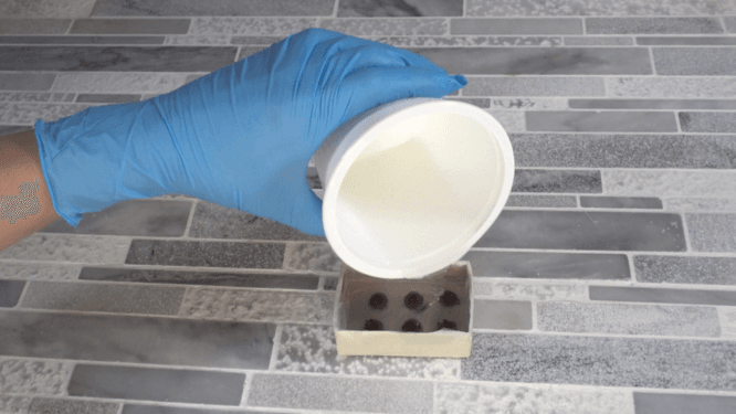 Pouring silicone to make chocolate chip mold