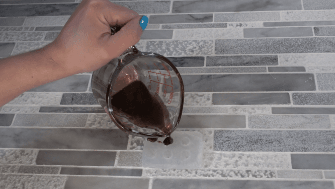 pouring melt and pour soap for chocolate chip mold embed