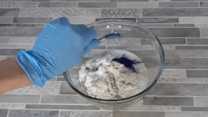 Bath bomb mixture colored pink with lake dye