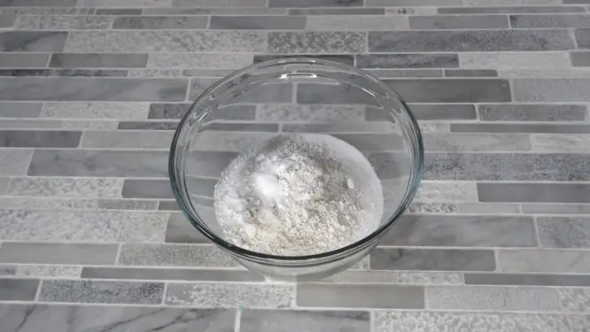 Mixing dry ingredients for bath bombs in a large bowl