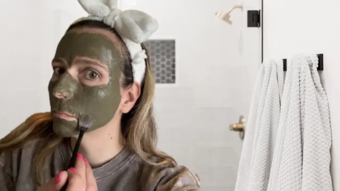 applying DIY clay face mask