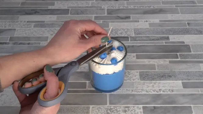 whipped candle triming the wick