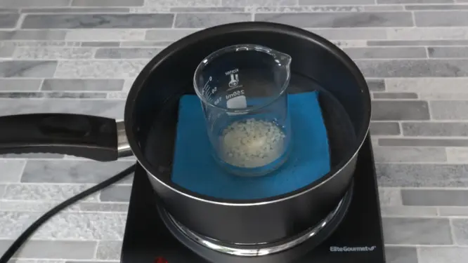 Lip balm ingredients melting in a double boiler