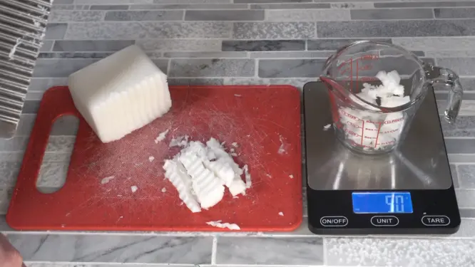 melt and pour soap base cut into small cubes being weighed on scale