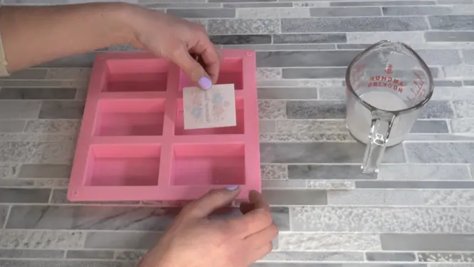 placing dissolvable soap embed picture side down in soap mold