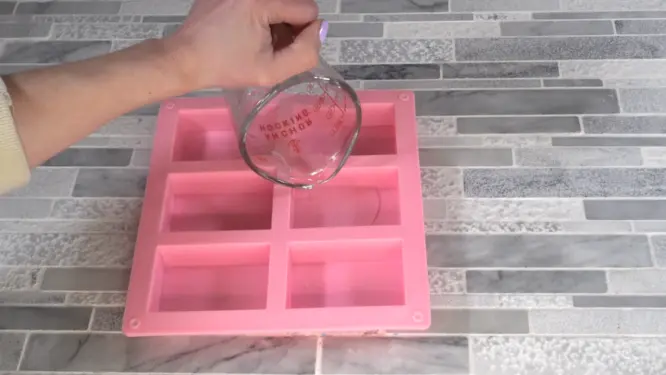 pouring clear melt and pour soap into mold