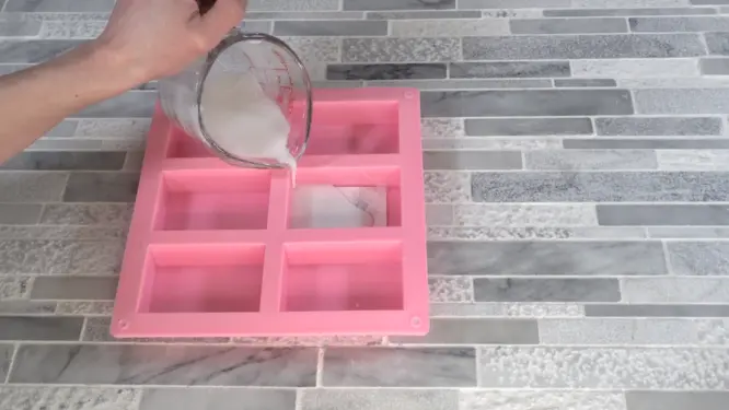 pouring white melt and pour soap over picture embed 