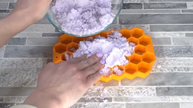 pressing shower steamer mixture into mold