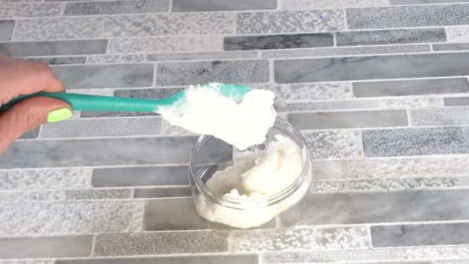 scooping thick creamy whipped sugar scrub into storage jars