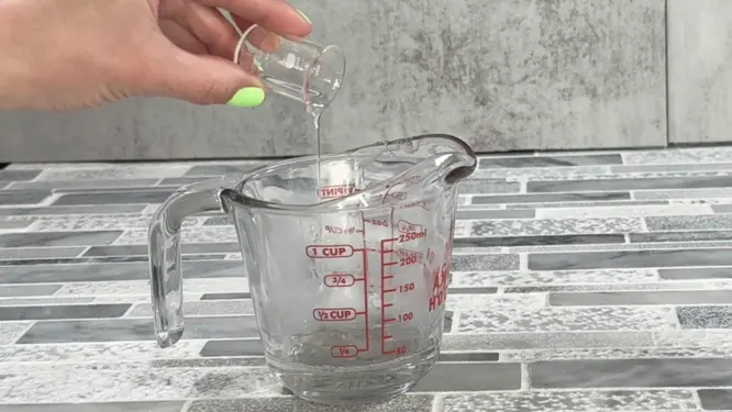 adding fragrance oil to melted soap base for a sugar scrub