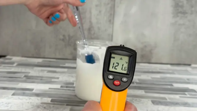 checking temperature of lotion before adding cool down ingredients