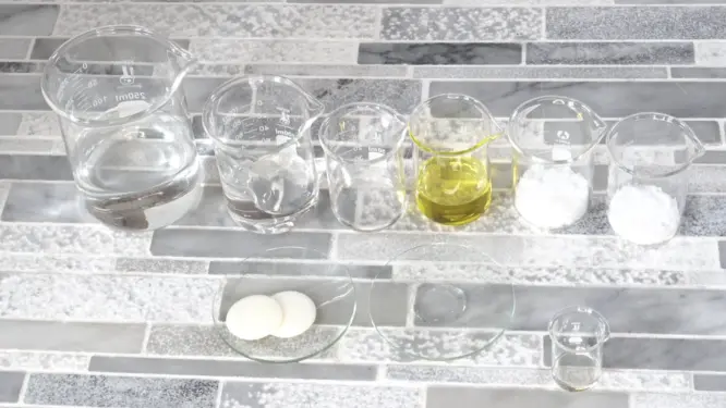 ingredients for diy aloe lotion including aloe gel jojoba oil and cocoa butter