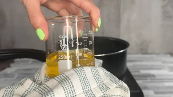 melted body butter mixture wiping water off container before adding oils
