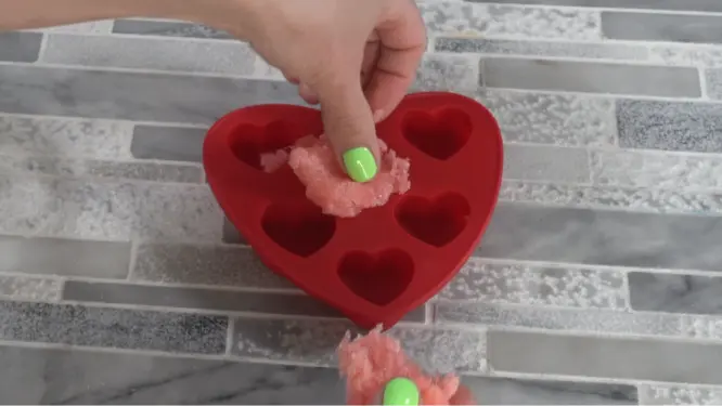 pressing sugar scrub into mold
